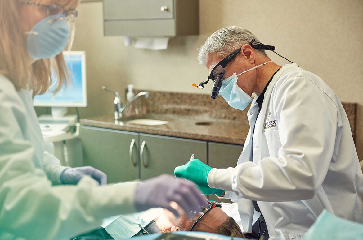 A dentist working on a patient at his dental practice