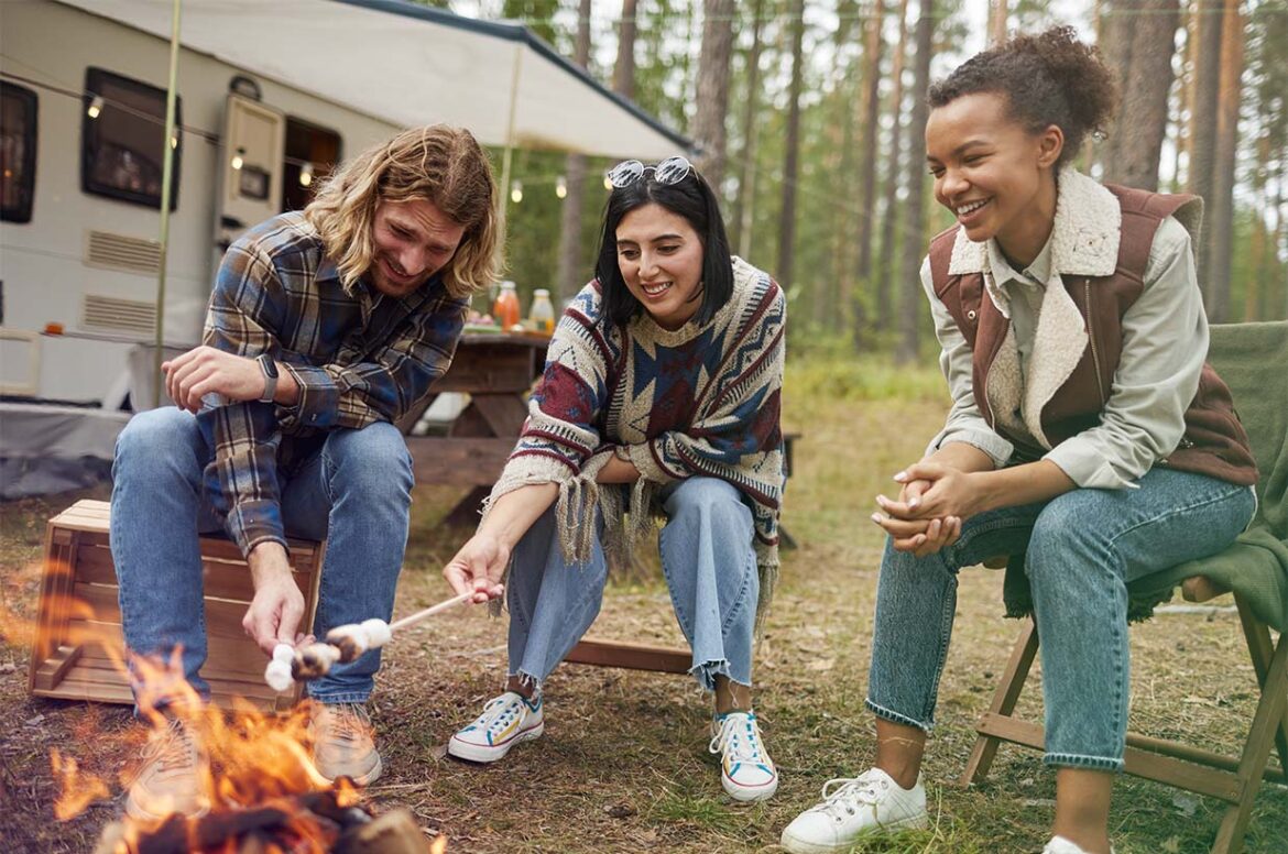 People sitting around a camp fire at a RV park or outdoor hospitality business