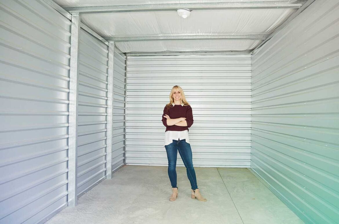 Self storage owner standing in a storage unit